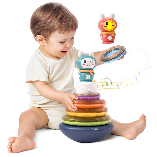 A little boy playing with baby musical stacking toys